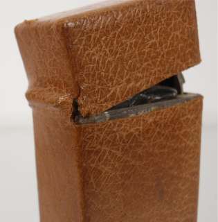 this early traveling ink well features a leather covering over a metal 