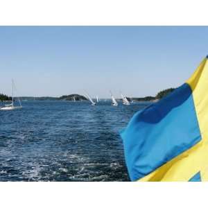 Swedish Flag with Sailboats in the Background, Stockholm Archipelago 